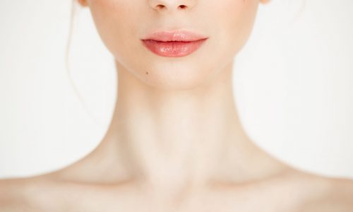 Close up of young nude beautiful girl with clean healthy skin over white background. Copy space. Cosmetology and spa.